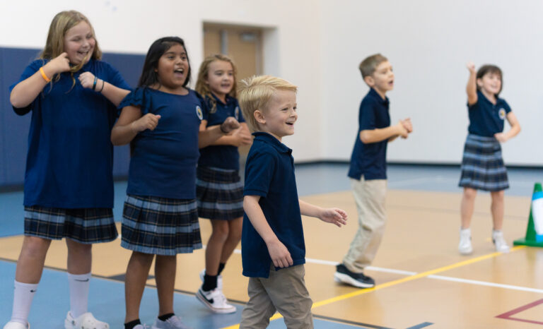 Students jump around and dance during their physical education class