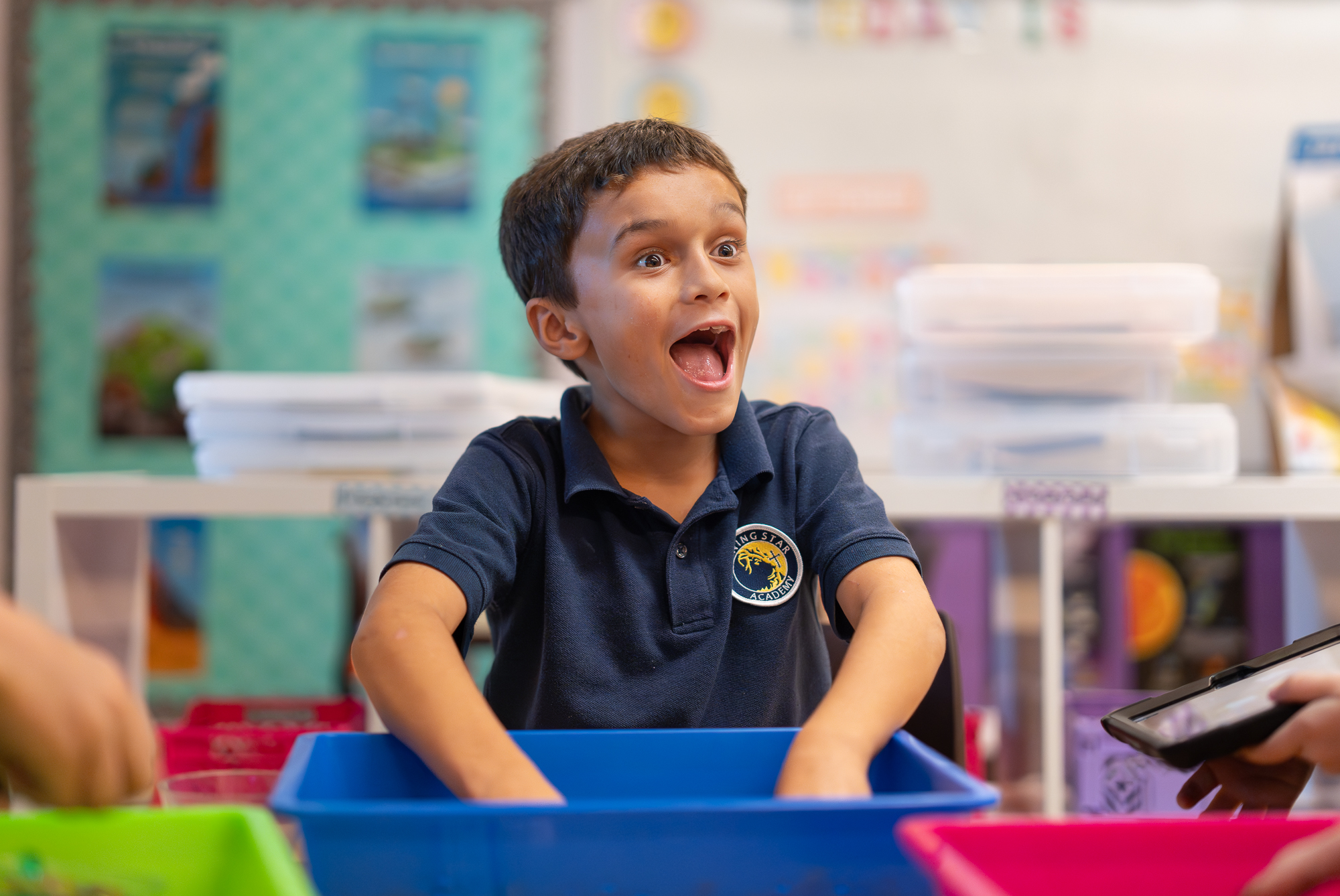 A student opens his mouth in excitement during a photo in art class